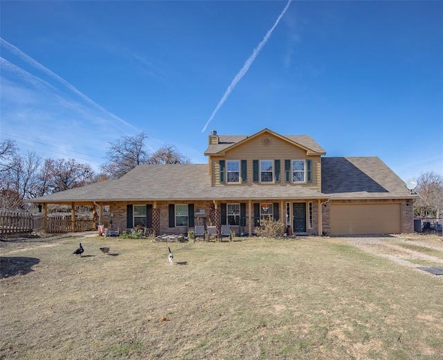 view of front of property featuring a front lawn and a garage