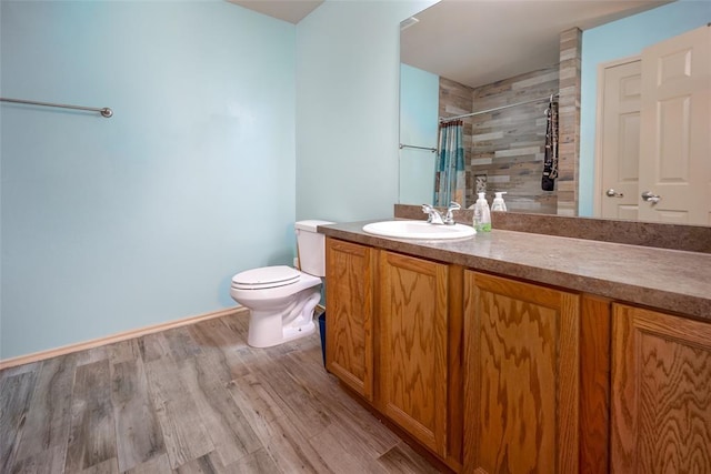 bathroom featuring vanity, hardwood / wood-style flooring, toilet, and walk in shower