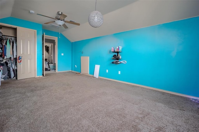 unfurnished bedroom featuring a closet, carpet floors, and vaulted ceiling