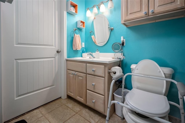 bathroom with tile patterned flooring, vanity, and toilet