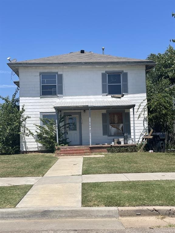 view of front property featuring a porch and a front yard