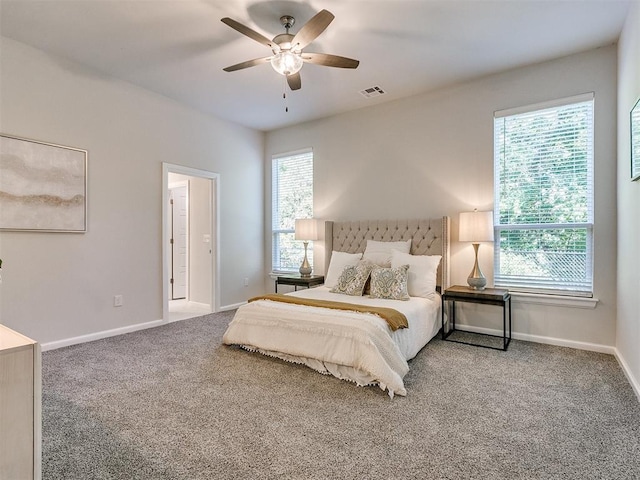 carpeted bedroom with multiple windows and ceiling fan