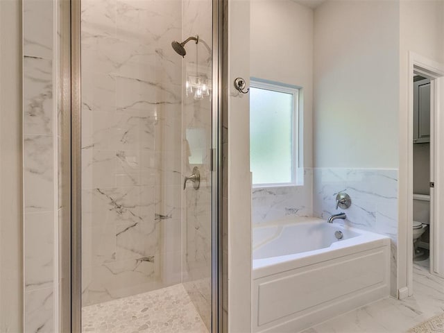 bathroom featuring toilet, tile walls, and shower with separate bathtub