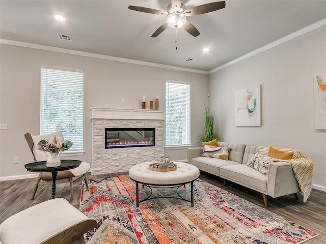 living room featuring dark hardwood / wood-style flooring, a wealth of natural light, ornamental molding, and ceiling fan