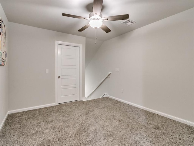 spare room featuring carpet floors and ceiling fan