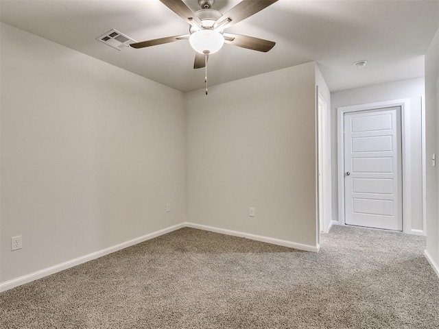 spare room with ceiling fan and carpet