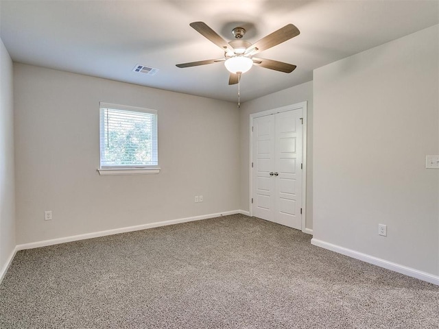 empty room featuring carpet and ceiling fan