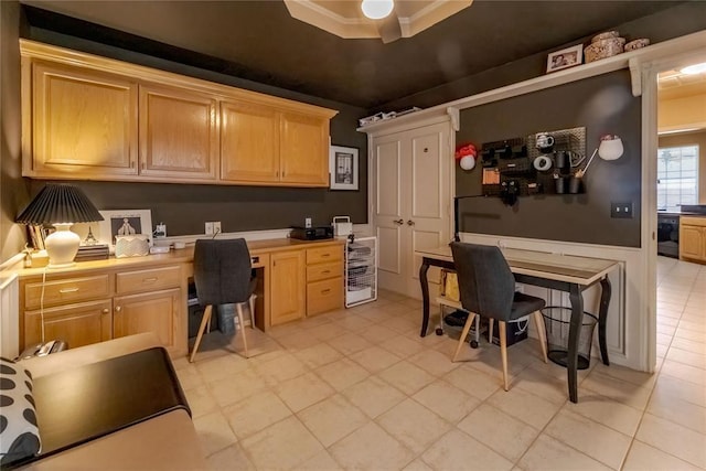 office area with built in desk, a tray ceiling, wine cooler, and ornamental molding