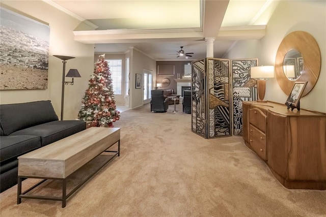 carpeted living room featuring decorative columns, ceiling fan, crown molding, and beamed ceiling