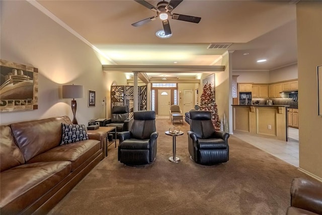 tiled living room featuring ornate columns, ceiling fan, and ornamental molding