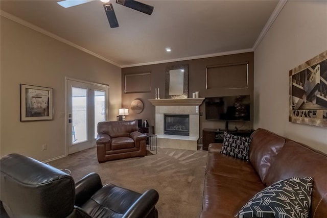 living room featuring carpet, ceiling fan, ornamental molding, and a fireplace