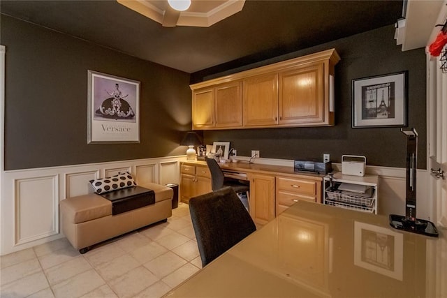 kitchen featuring light tile patterned floors, built in desk, and light brown cabinetry