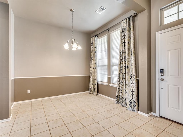 foyer with an inviting chandelier and light tile patterned floors