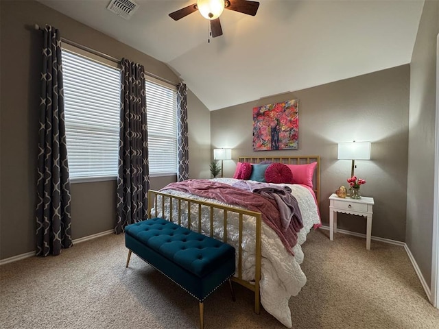 carpeted bedroom with ceiling fan and vaulted ceiling