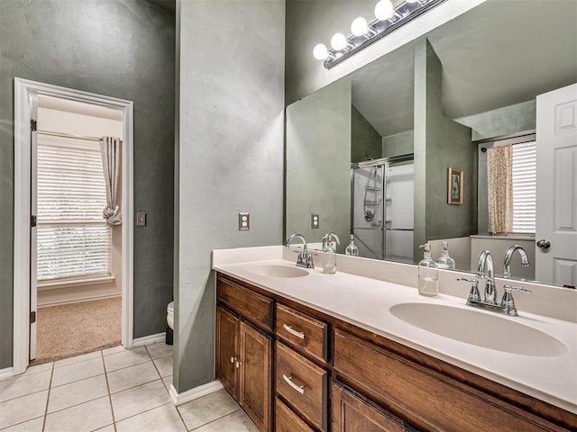 bathroom with tile patterned flooring, vanity, plenty of natural light, and toilet