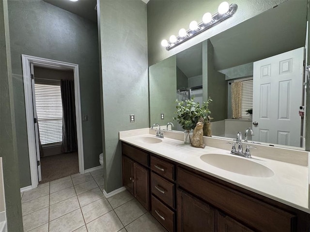 bathroom featuring vanity, toilet, and tile patterned flooring