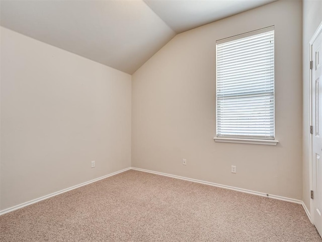 bonus room with a healthy amount of sunlight, lofted ceiling, and carpet floors