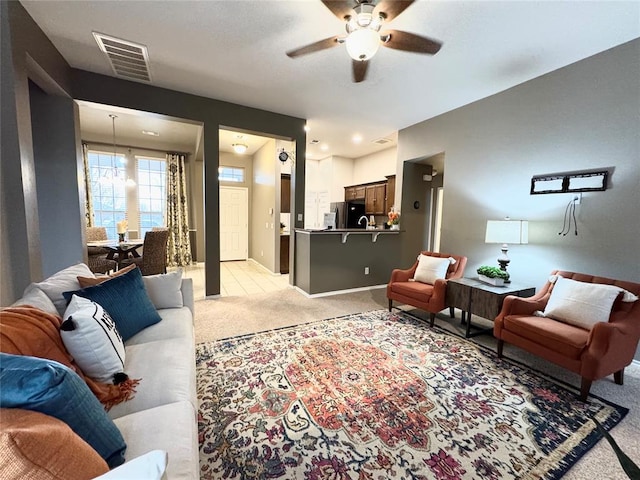 carpeted living room featuring ceiling fan