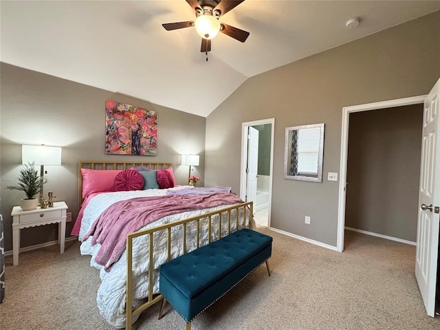 bedroom featuring ceiling fan, ensuite bathroom, carpet floors, and lofted ceiling