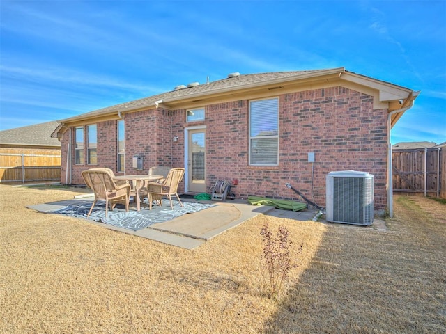 rear view of house with a yard, central AC, and a patio