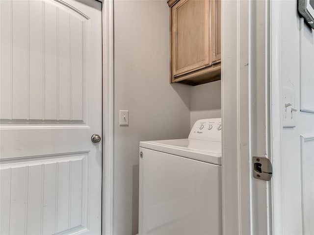 washroom with cabinets and washer / dryer