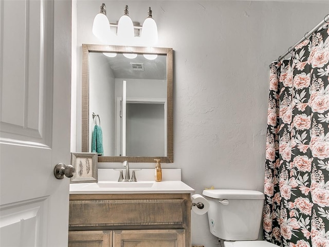 bathroom with vanity and toilet