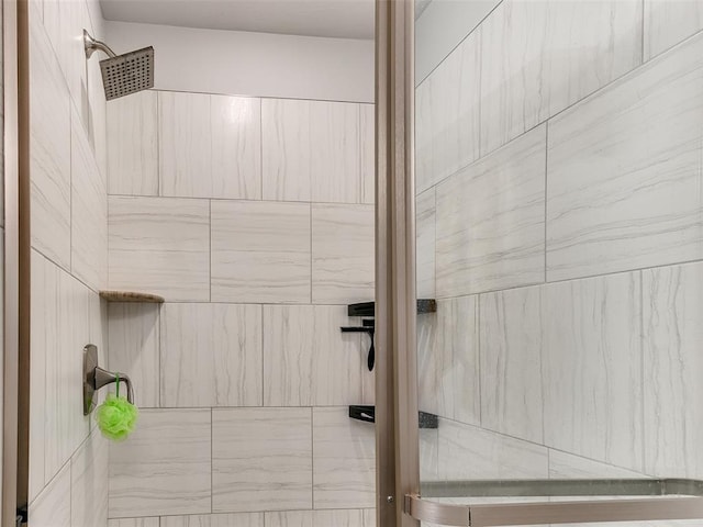 bathroom with tiled shower