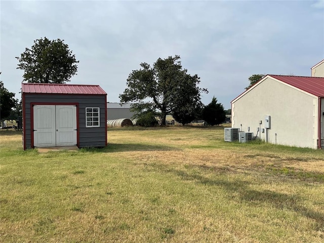 view of yard with a storage shed and central AC unit