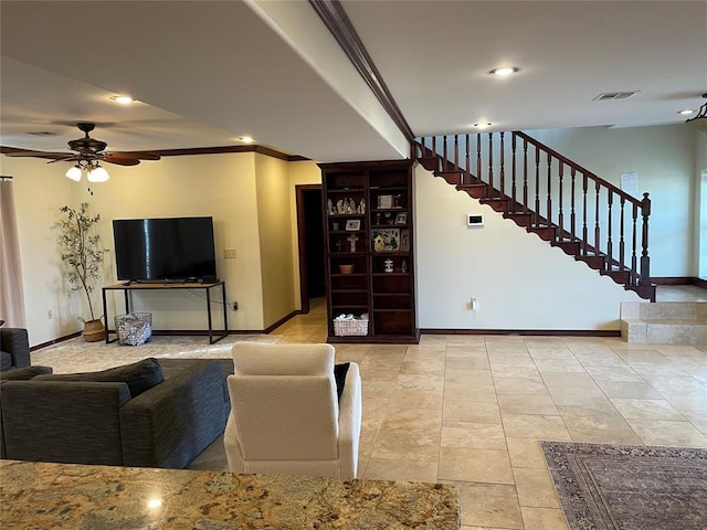 living area with crown molding, a ceiling fan, and baseboards