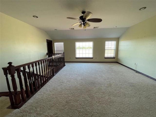 unfurnished room with a ceiling fan, lofted ceiling, visible vents, and carpet floors