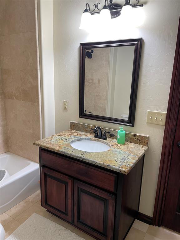 bathroom with tile patterned floors, vanity, and tub / shower combination