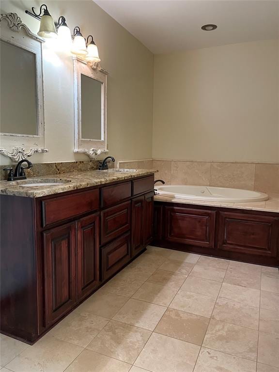 bathroom featuring a bath, double vanity, tile patterned flooring, and a sink