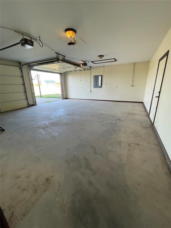 garage featuring electric panel and a garage door opener
