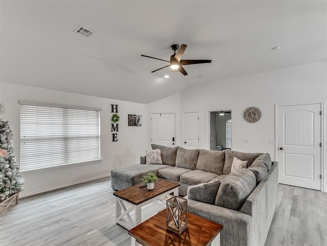 living room with ceiling fan, lofted ceiling, and light wood-type flooring