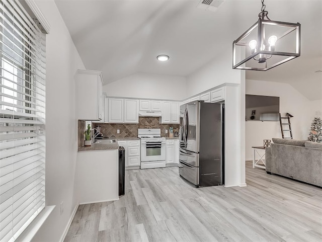 kitchen with lofted ceiling, white cabinets, hanging light fixtures, stainless steel refrigerator with ice dispenser, and white gas stove