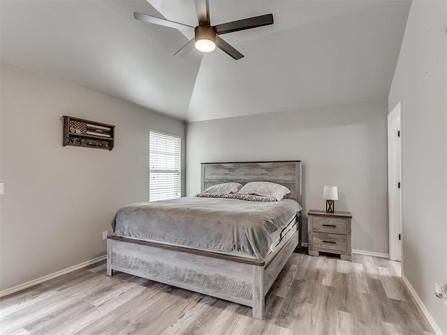 bedroom featuring lofted ceiling, ceiling fan, and light wood-type flooring