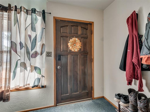 view of carpeted entrance foyer