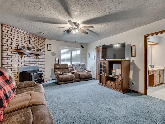 living room featuring a wood stove, ceiling fan, light colored carpet, and a textured ceiling