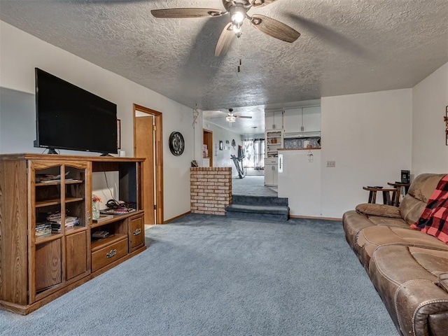 living room featuring carpet and a textured ceiling