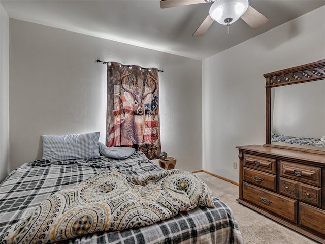 bedroom with ceiling fan and light carpet