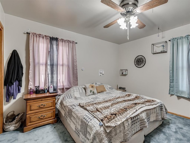 bedroom with ceiling fan and light carpet