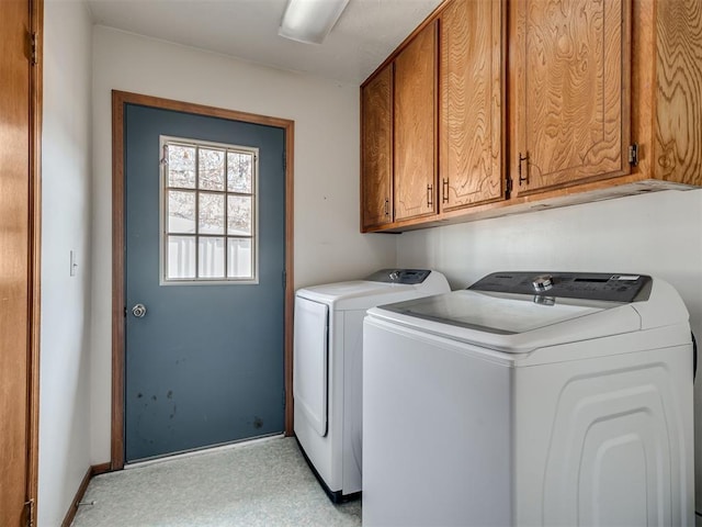 laundry area with washer and clothes dryer and cabinets