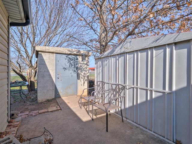 view of patio featuring a shed