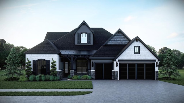 view of front of home with stone siding, concrete driveway, and a front yard