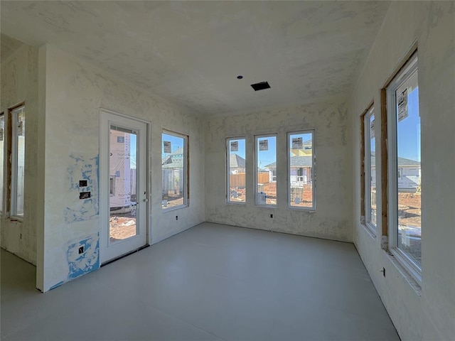 unfurnished sunroom featuring plenty of natural light