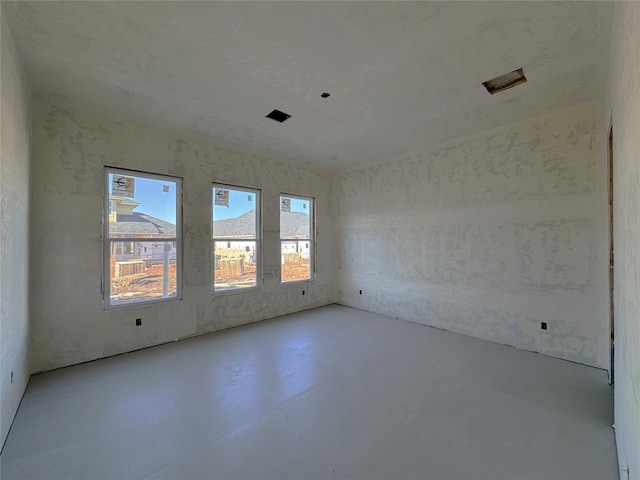 spare room with concrete floors