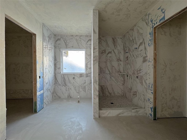 full bathroom featuring a marble finish shower