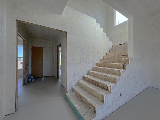 stairway with concrete flooring