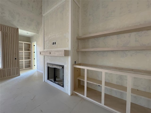 unfurnished living room with a glass covered fireplace