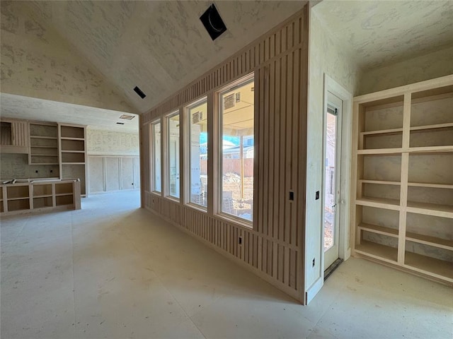 spare room featuring lofted ceiling